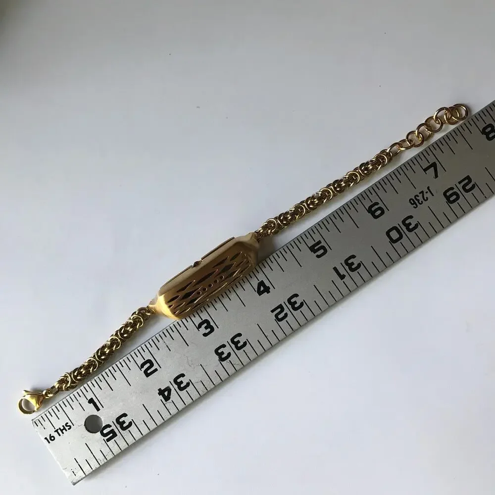 Brushed gold tone bracelet w/ a compartment for a fitbit device